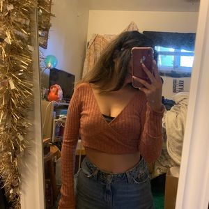cropped red-orange long sleeve crop top